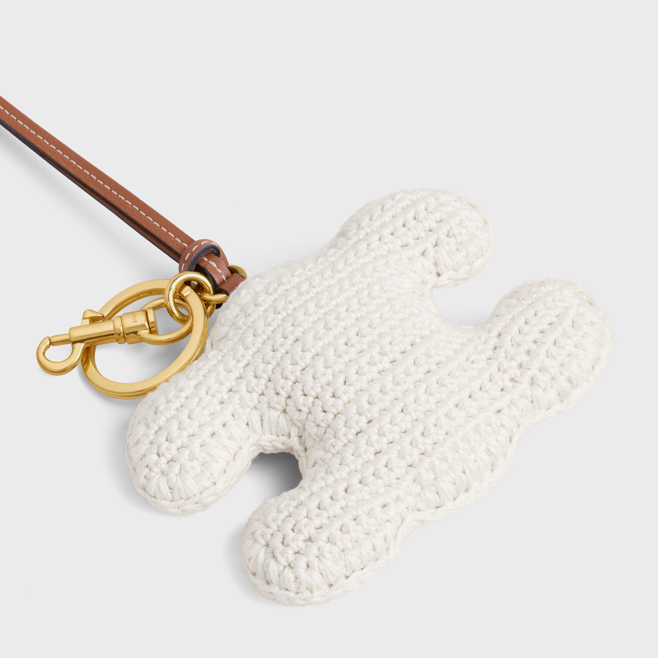 TRIOMPHE Pompon-Aufhänger aus Baumwoll-Strick mit Gold-Finish